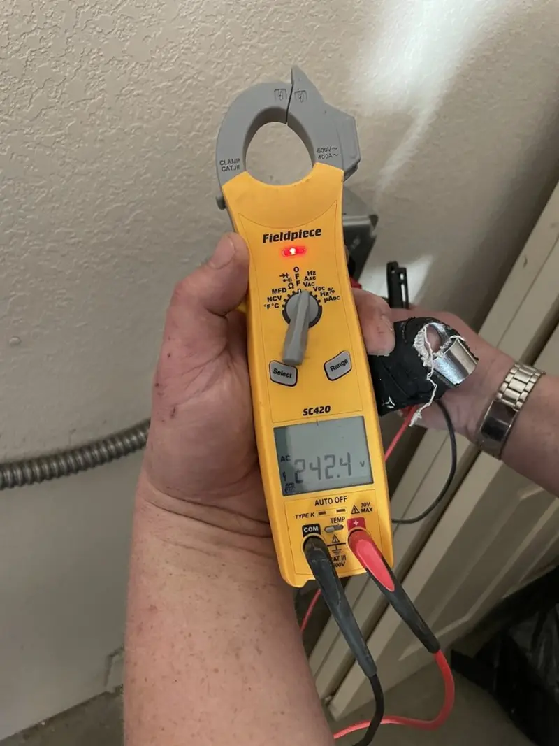 Voltage testing with clamp meter during Ceiling Fan Installation in Romulus